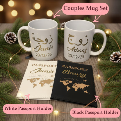 Two white mugs with personalized text, two passport holders (one white and one black), and decorative elements on a wooden surface.