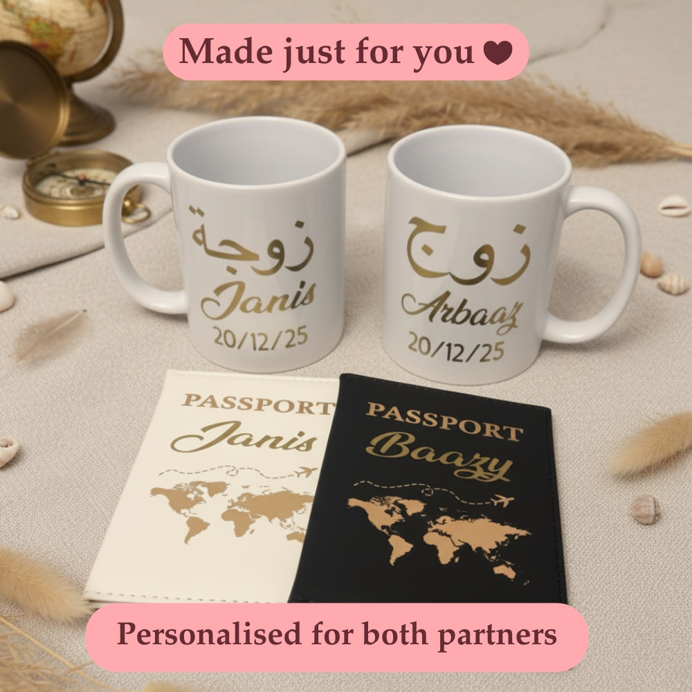 Two white mugs with gold text, two personalized passport covers, and a pink banner with text on a beige surface.